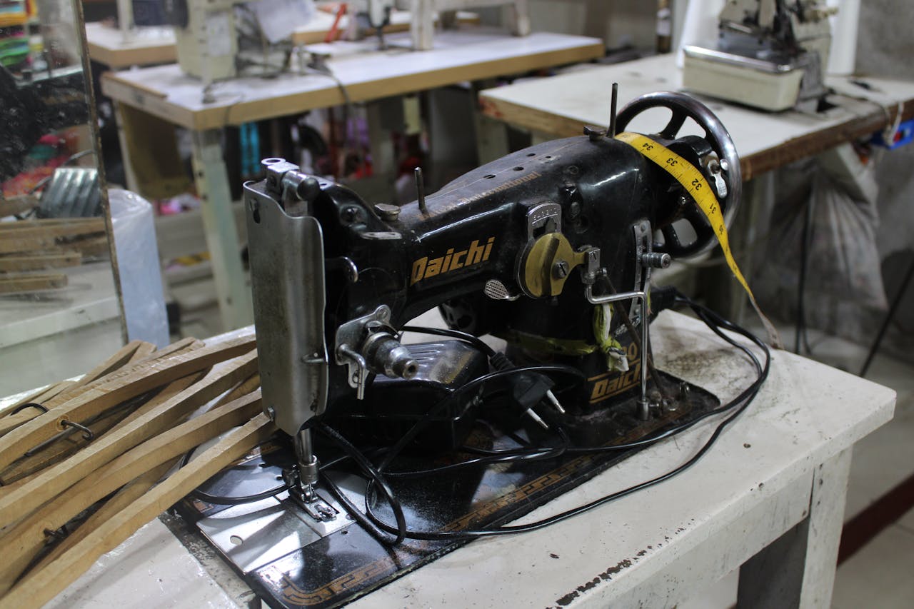 Close-up of an antique Daiichi sewing machine on a tailors table.